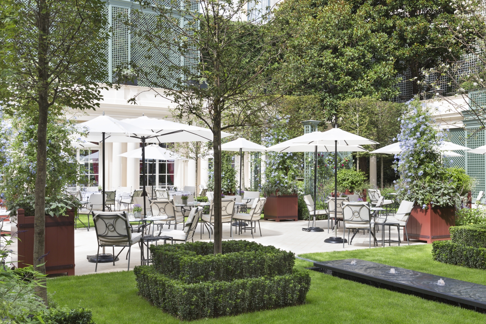 Terrace dining in the gardens of luxury hotel Le Bristol in Paris, France