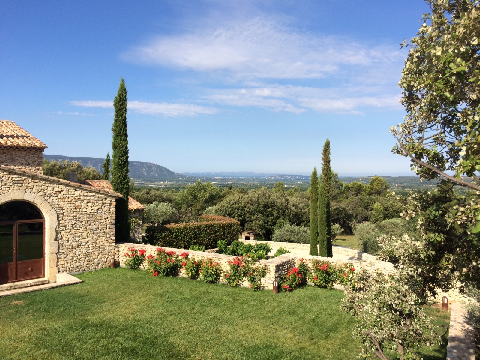 Garden with flowers, trees and countryside view at Le Clos in Provence, France