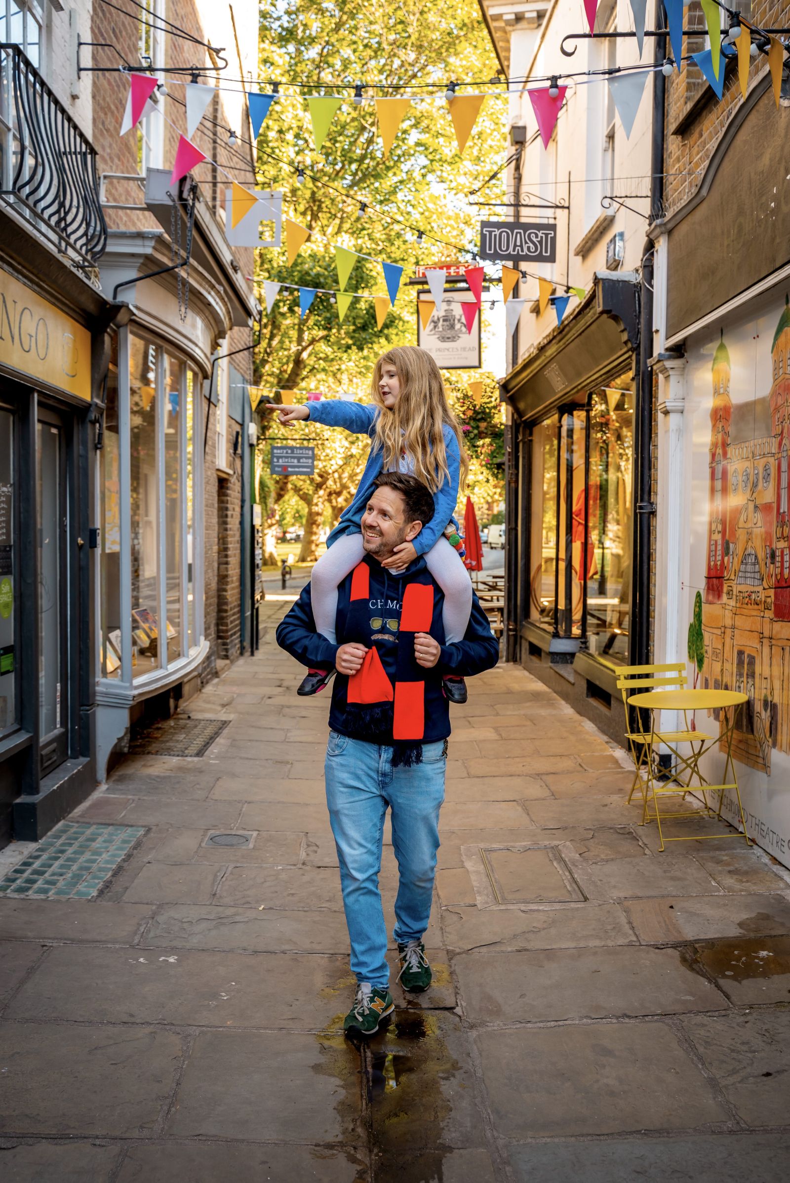 A father and daughter walking through Richmond Upon Thames in London