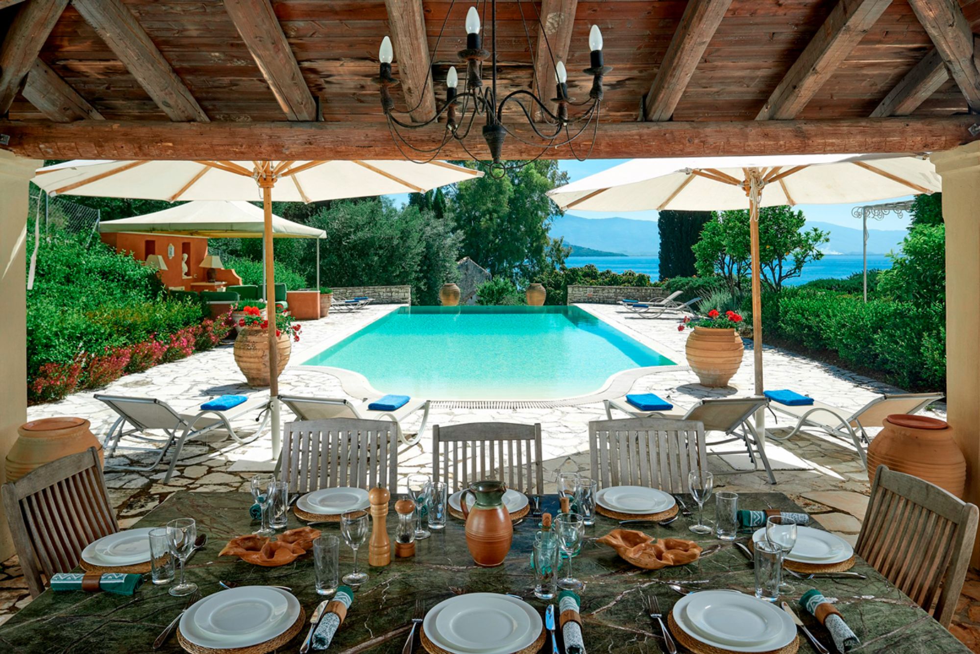 Pool and outdoor dining area at Kouloura Beach House