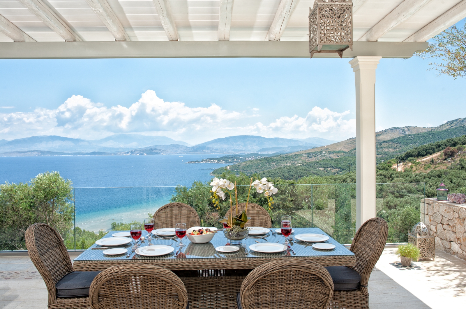 Outdoor dining table set for lunch with view towards the sea at Villa Dionysos, Corfu