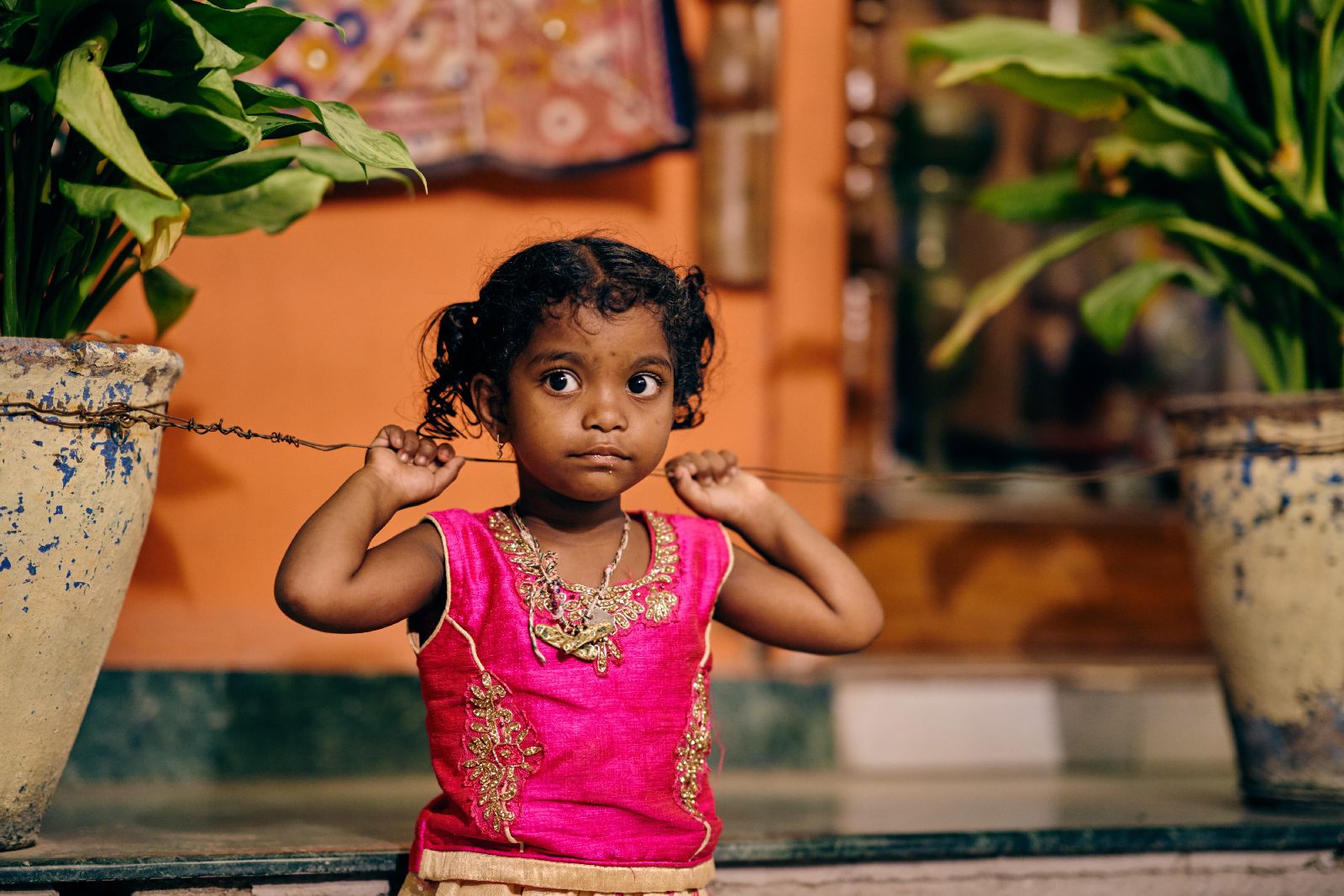 Young girl in bright pink traditional dress in India