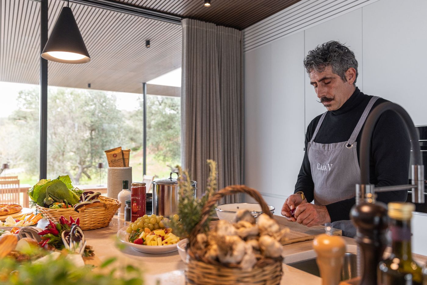A handsome chef preparing food in Villa Venere.