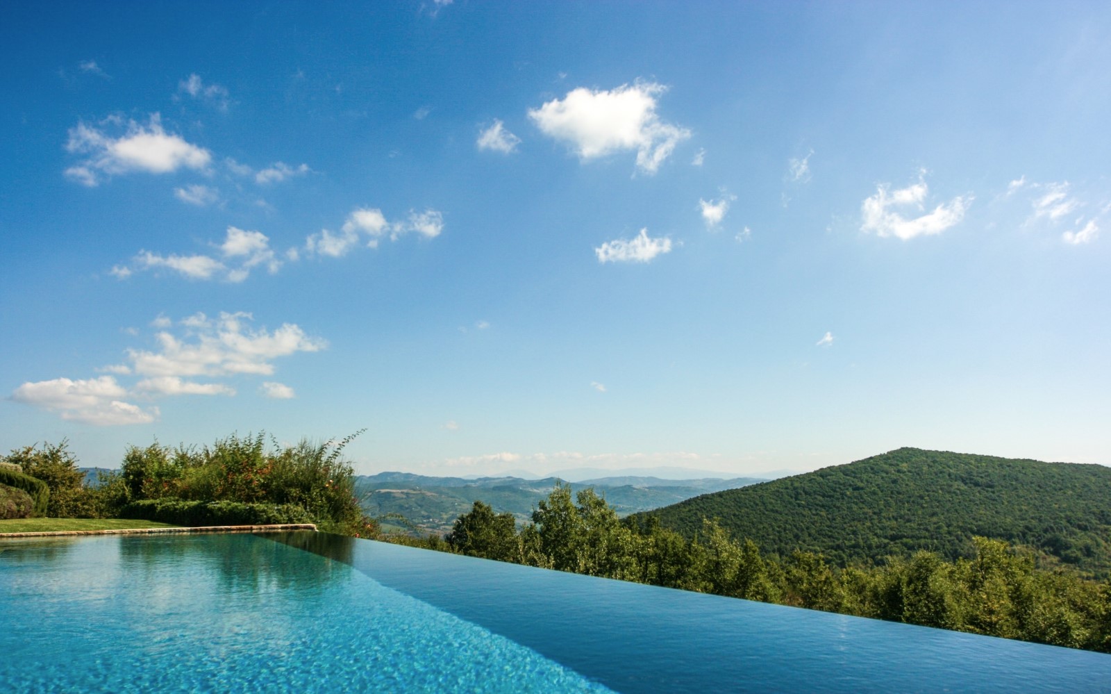 Infinity pool with countryside view at Monticello in Umbria, Italy