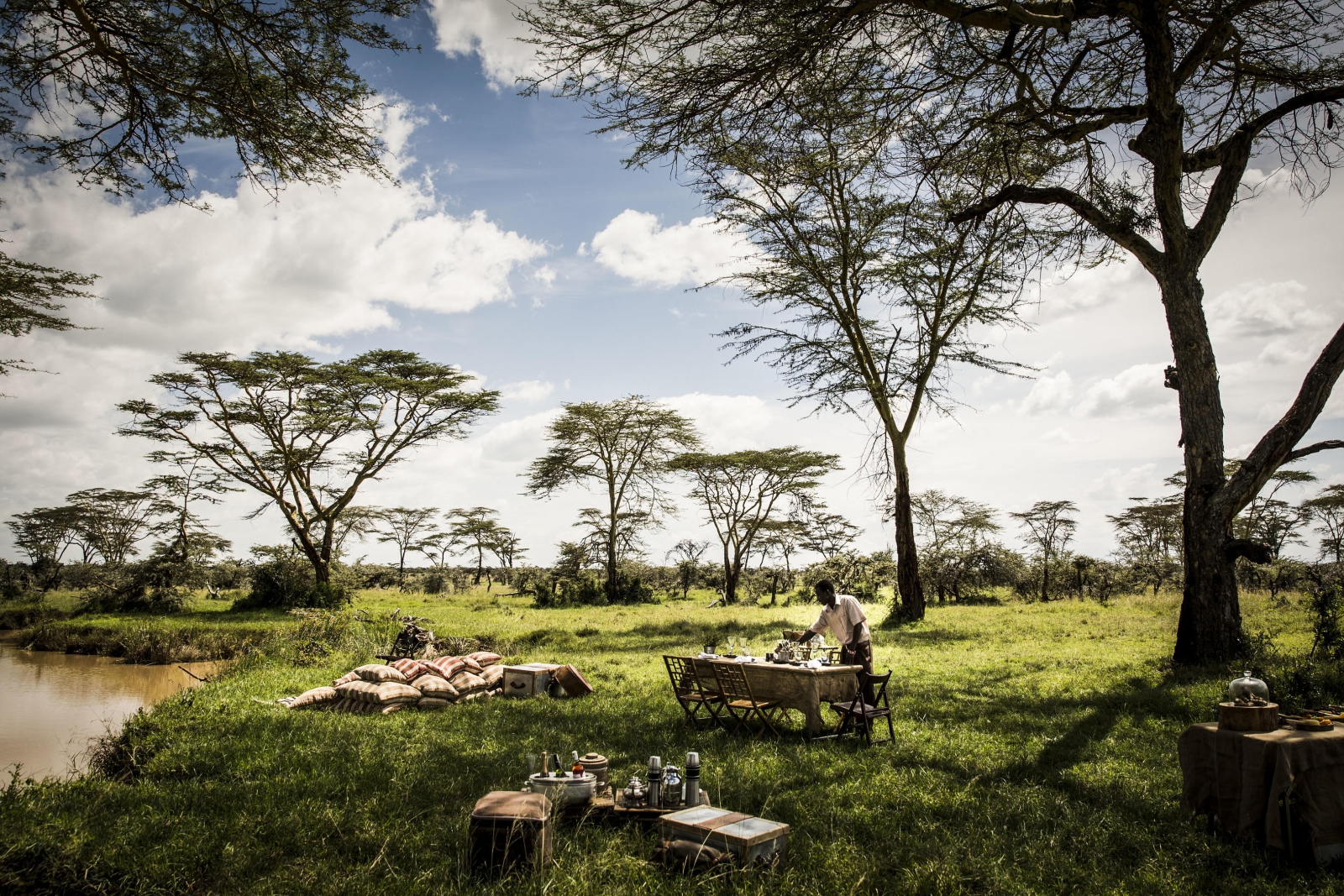 Picnic by a watering hole at luxury safari lodge Segera in Kenya 