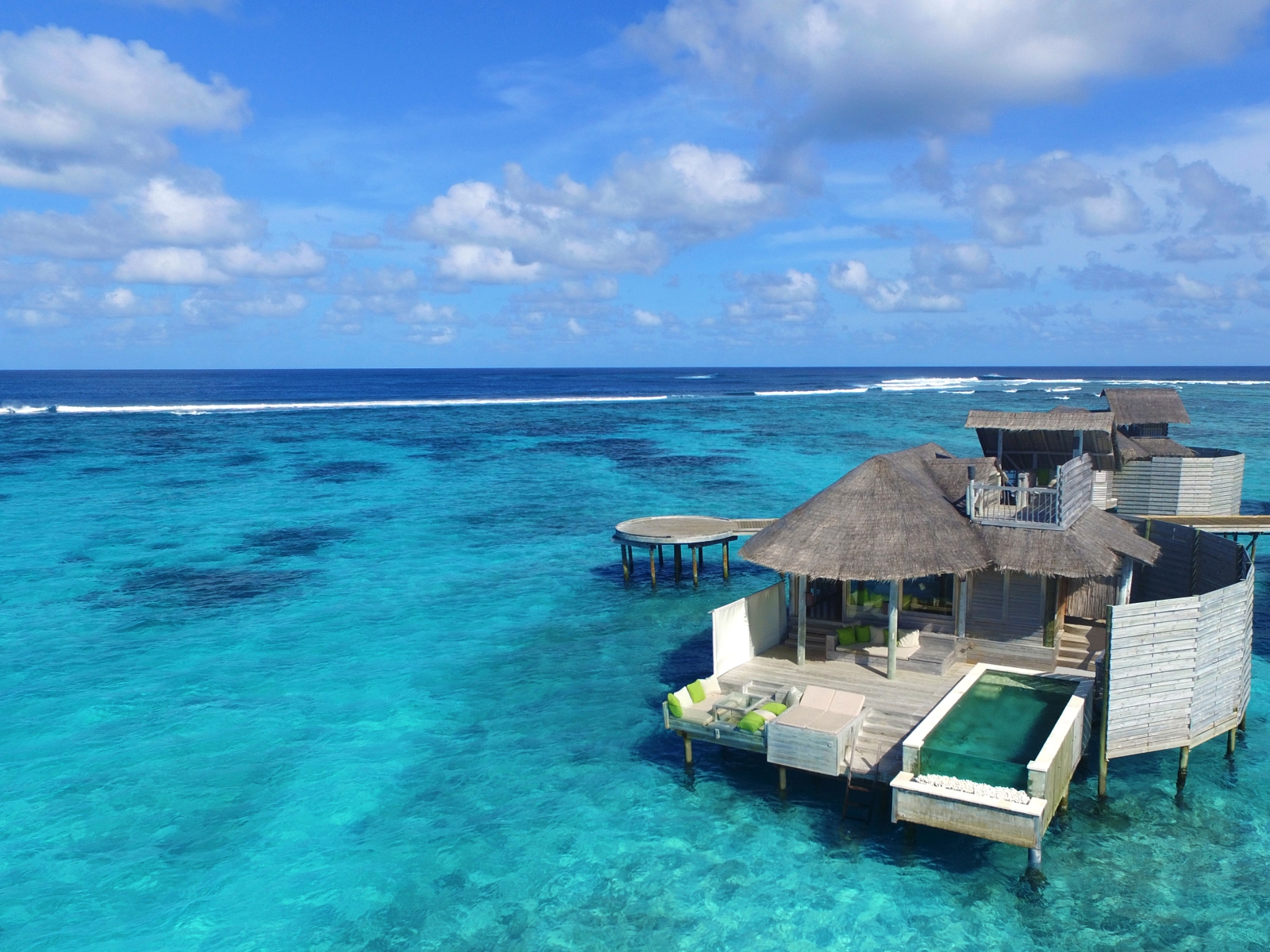 Aerial view of a Water Villa with a Pool at Six Senses Laamu