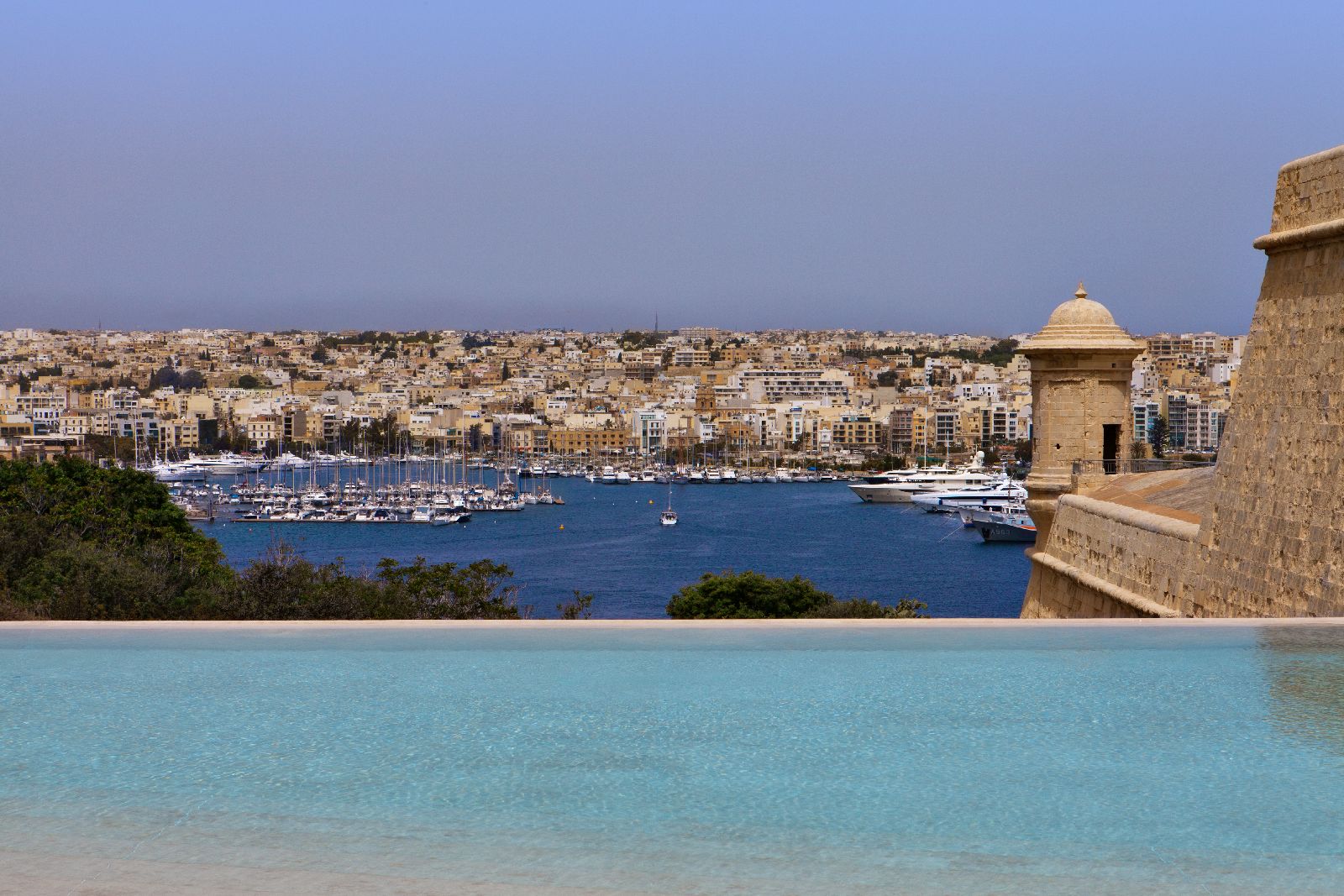 Bastion and harbour views from the infinity pool at The Phoenica Malta hotel in Valletta