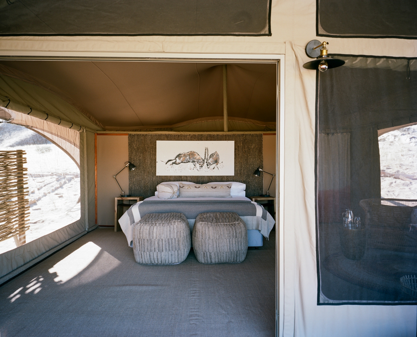 Tented bedroom with animal drawing over bed