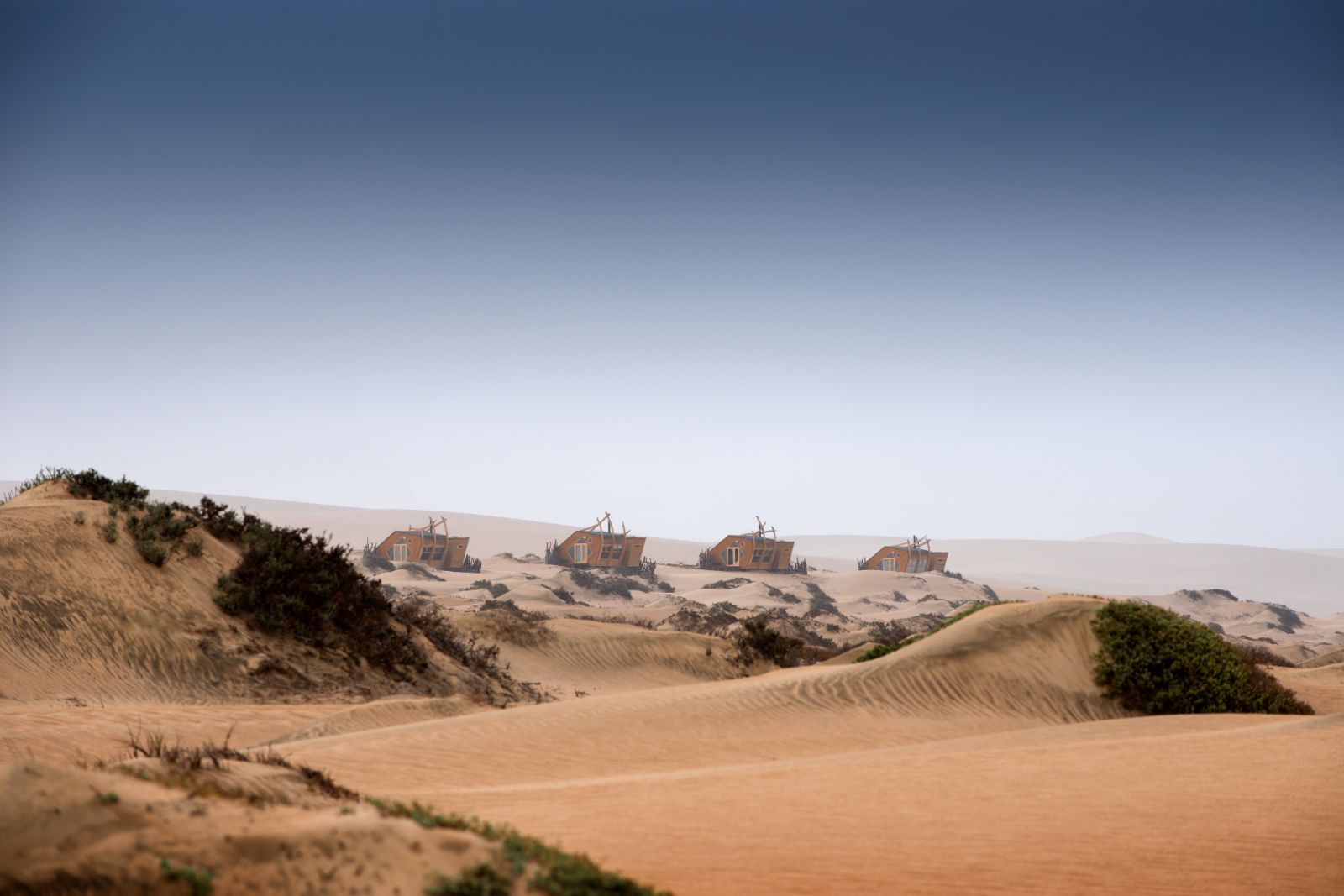 Exterior view of the cabins at luxury lodge Shipwreck Lodge in the Skeleton Coast National Park, Namibia