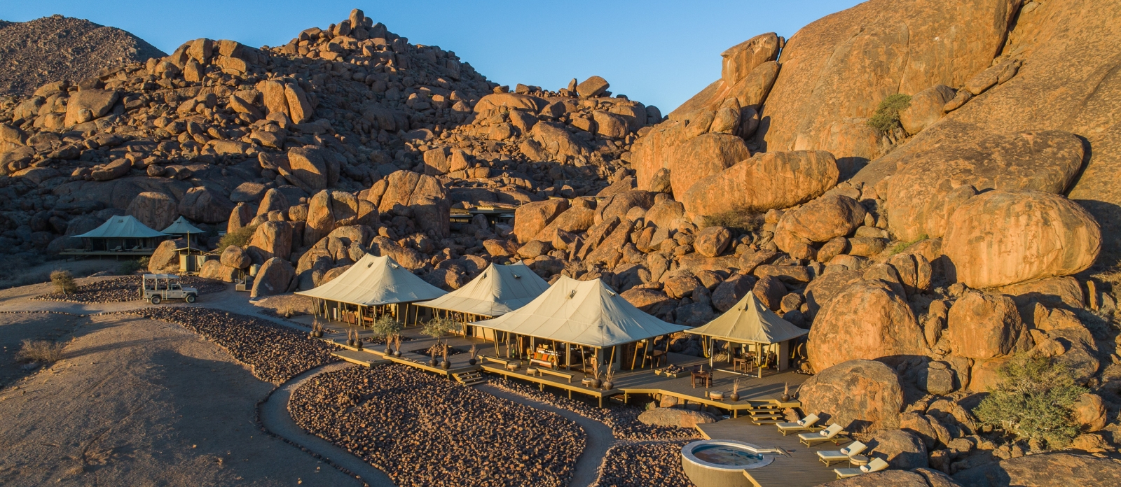 Aerial view of the camp set against boulders at sunset