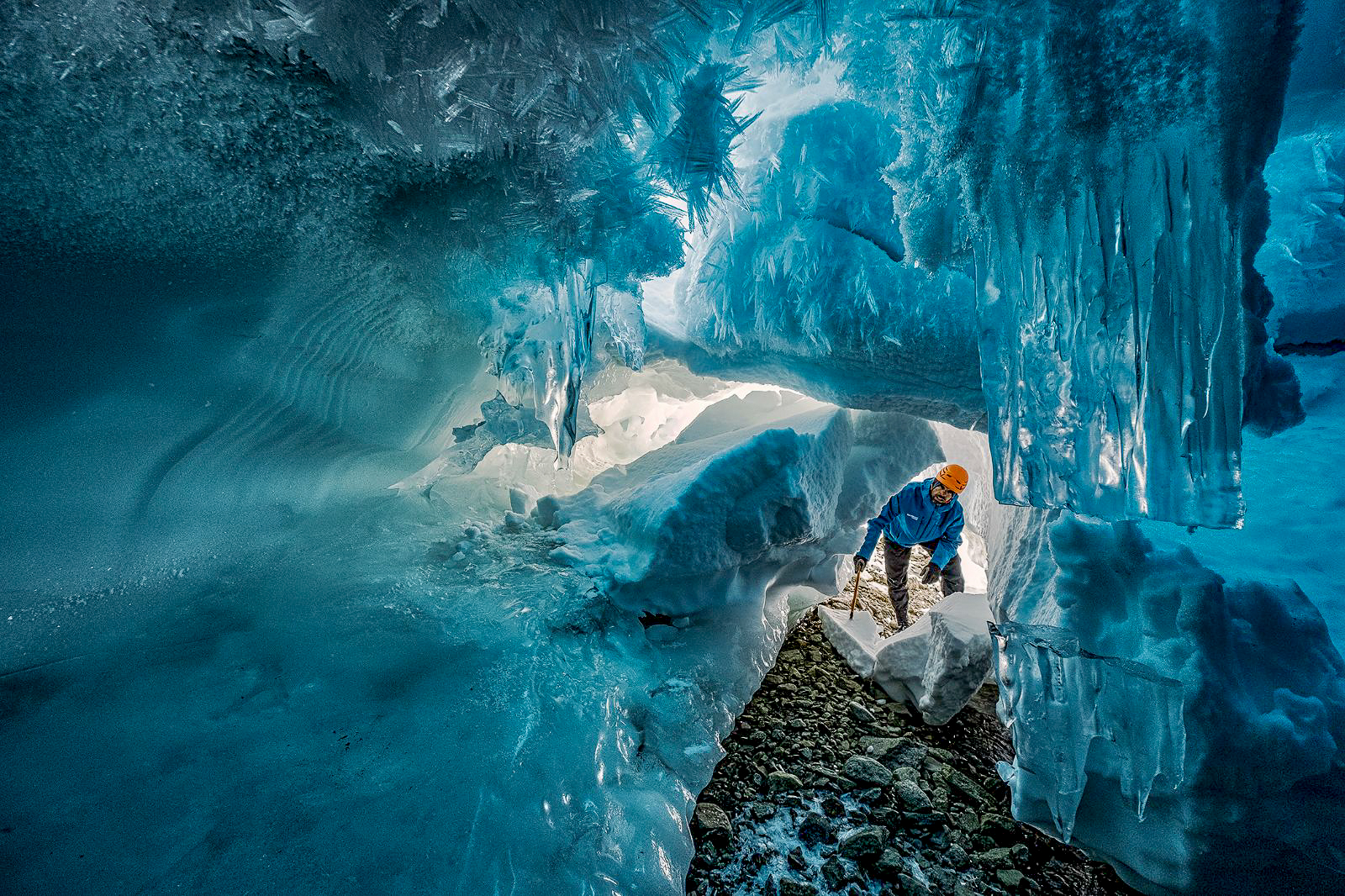A man exploring an ice cave near Whichaway by White Desert in Antarctica