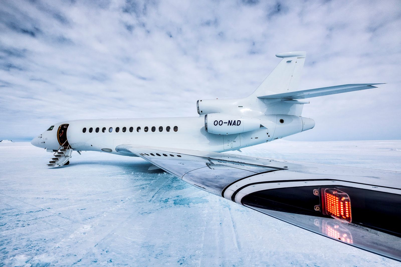 Private jet parked on snow covered runways