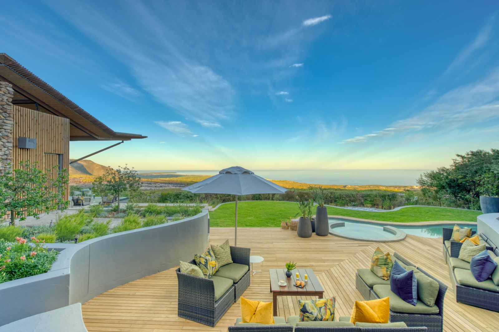Outdoor lounge area with sofas by the pool at luxury lodge Grootbos Garden Lodge in South Africa