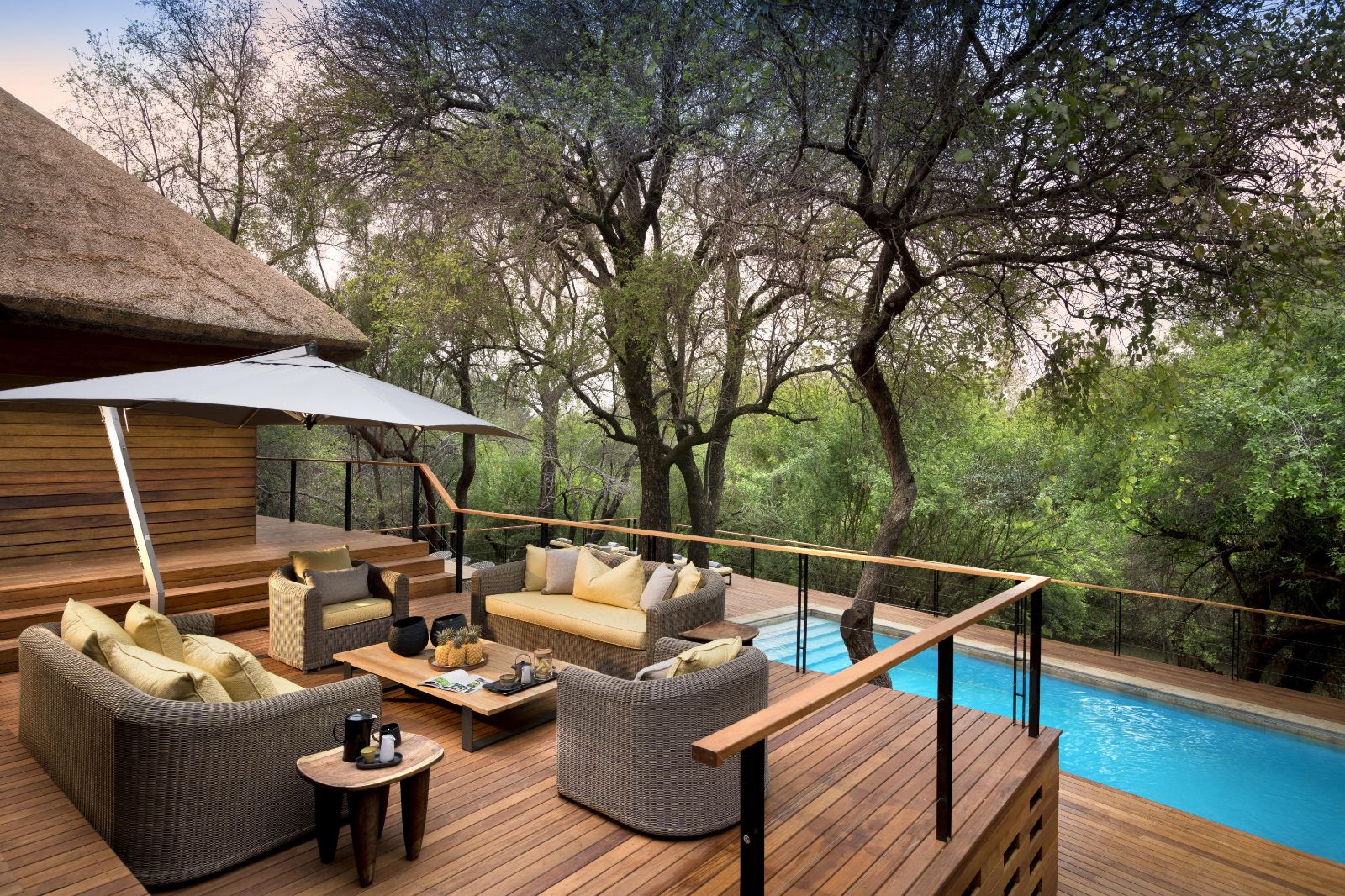 Poolside lounge area with fresh fruit and drinks at luxury private house Morukuru River House in the Madikwe Game Reserve in South Africa