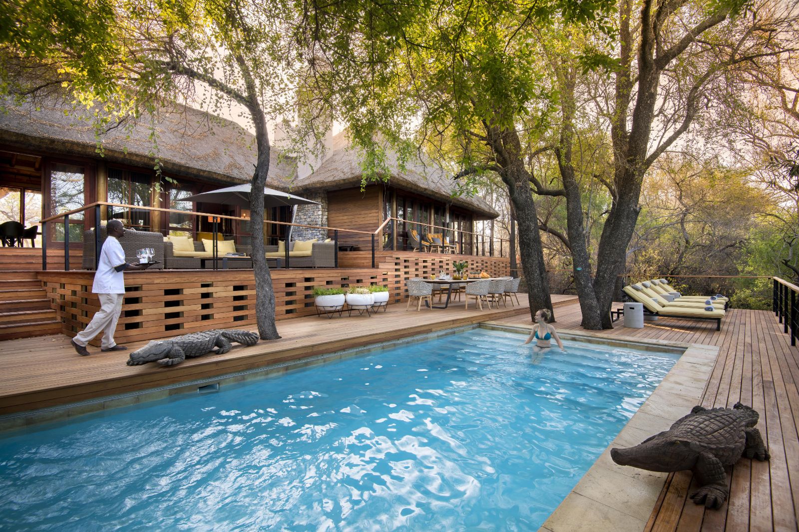 Guest enjoying a dip in the cooling pool at luxury private house Morukuru River House in the Madikwe Game Reserve in South Africa