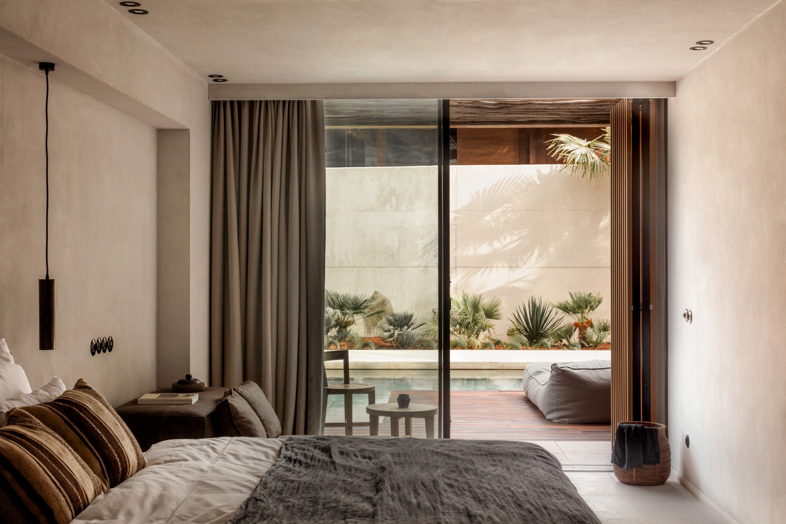 Bedroom with pool access at luxury resort OKU Ibiza