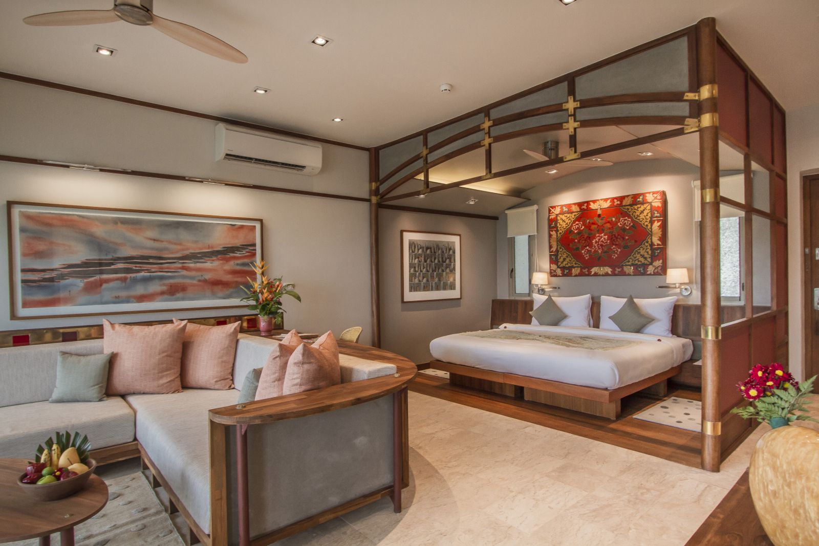 Beautifully decorated interior of a Garden Pool Superior Suite with seating area and double bed at at luxury wellness resort Kamalaya in Thailand