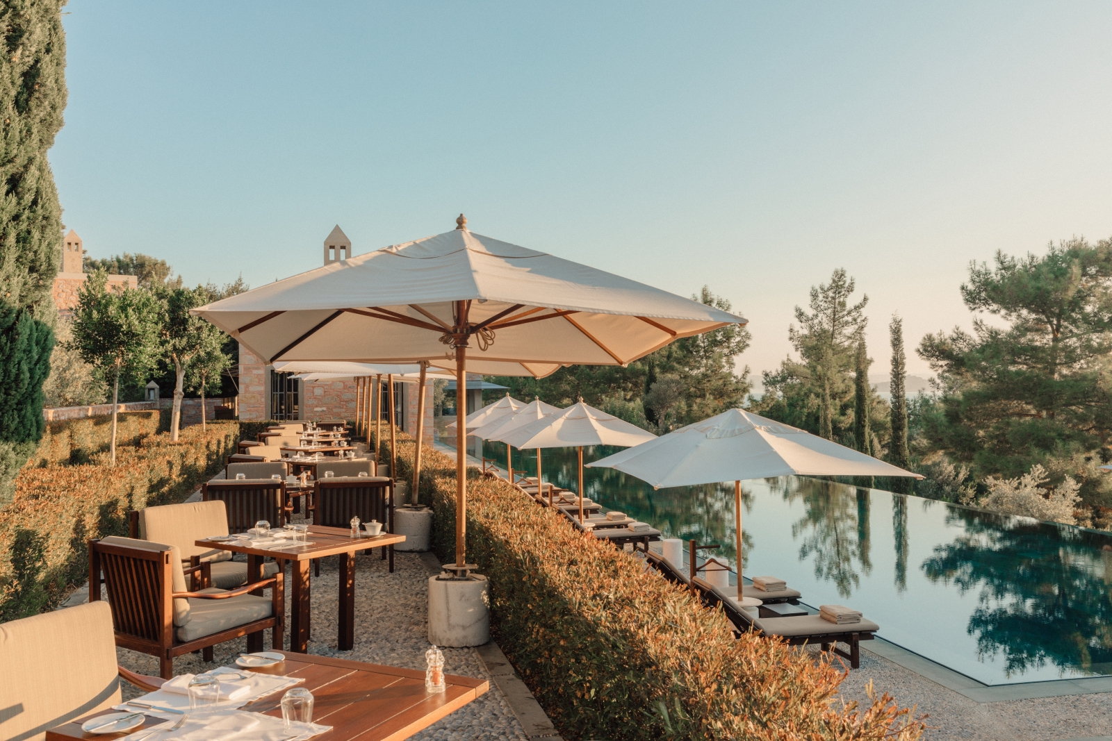 Terrace dining by the pool with sea views at luxury hotel Amanruya, Turkey