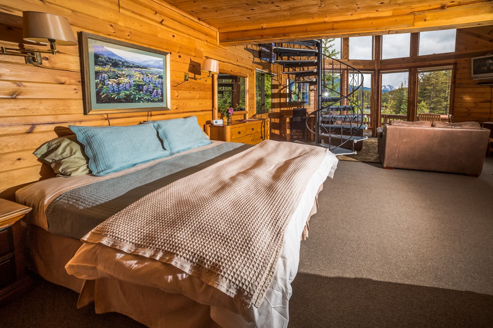 Kittiwake Cabin bed and window view at Tutka Bay Lodge in Alaska, USA